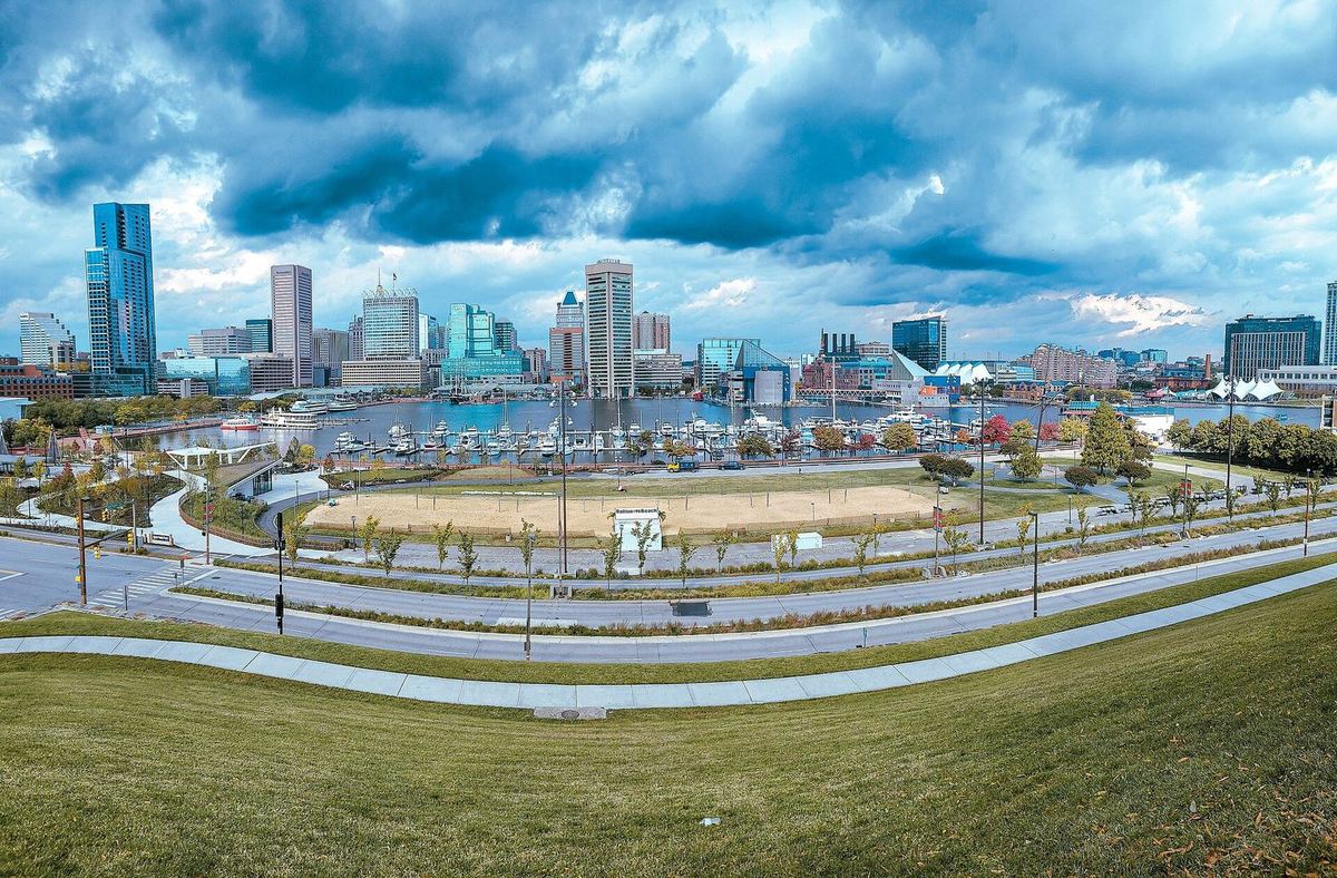 Baltimore’s Inner Harbor and downtown skyline from Federal Hill under a stormy sky